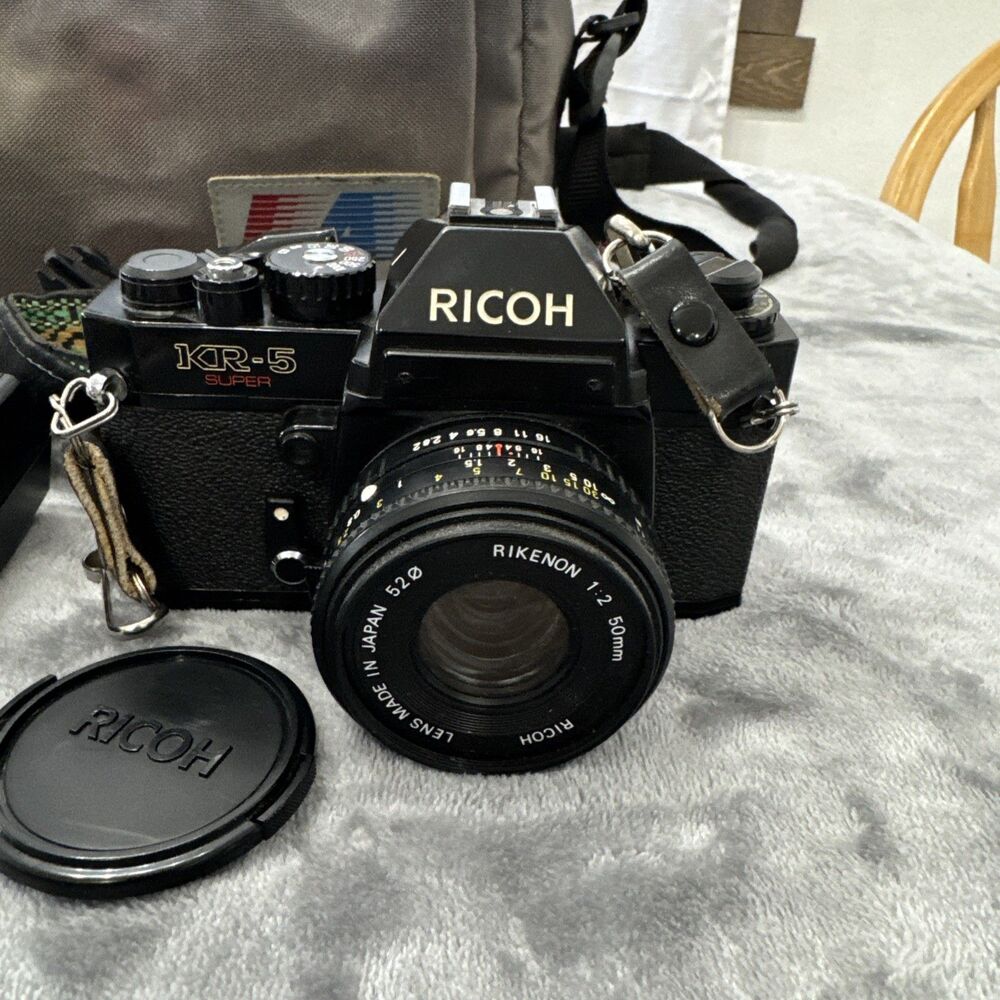 Ricoh KR-5 Film camera with lenses, flash, lens case, and camera bag.tested